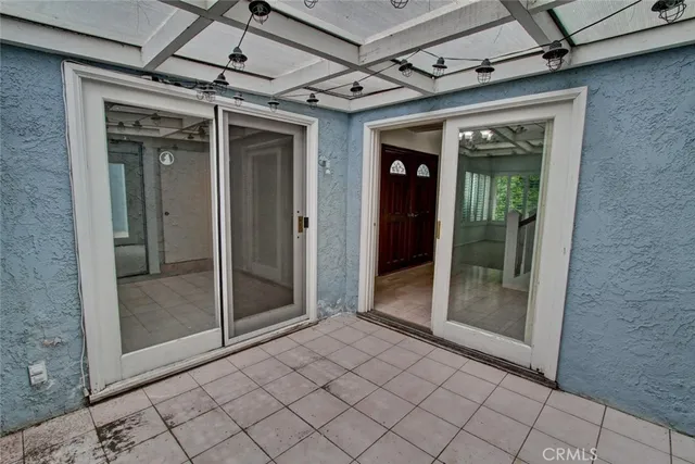 a bathroom with a double vanity sink and mirror with toilet