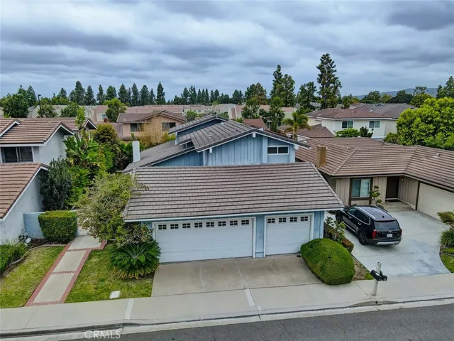 a aerial view of a house with a yard and potted plants
