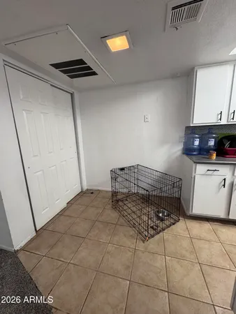 a living room with a washing machine and a sink