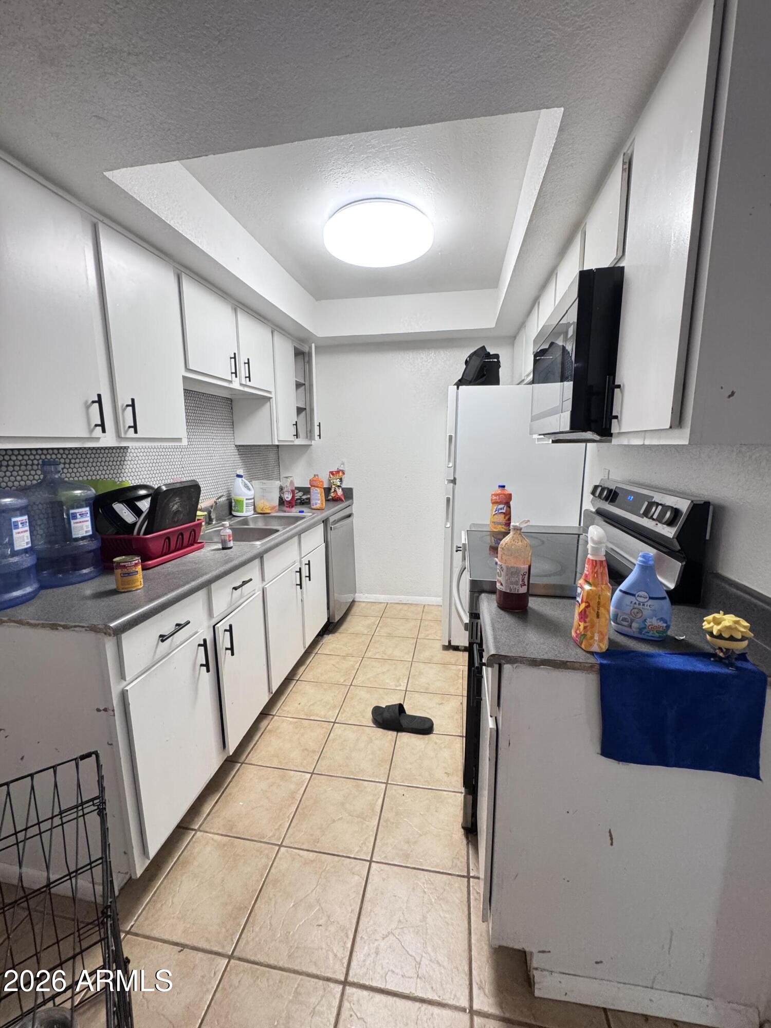 1336 East Mountain View Road, Unit 201 Phoenix, AZ 85020 - Photo 14 of 16 a kitchen with stainless steel appliances kitchen island granite countertop a sink and cabinets