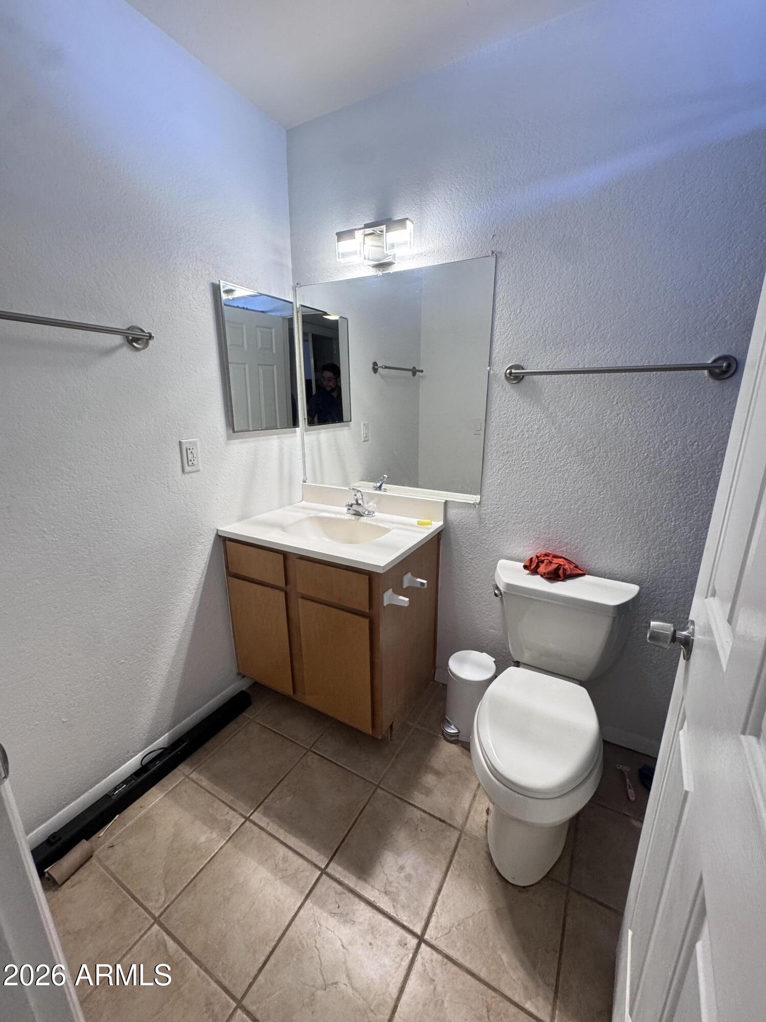 1336 East Mountain View Road, Unit 201 Phoenix, AZ 85020 - Photo 6 of 16 a bathroom with a toilet sink and mirror