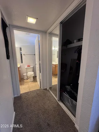 a living room with a large mirror next to a glass door