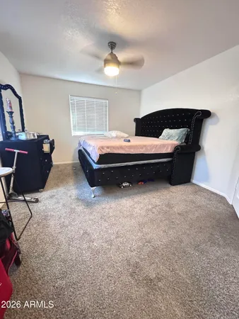 a bedroom with bed and window