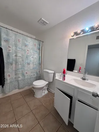 a bathroom with a toilet sink and shower