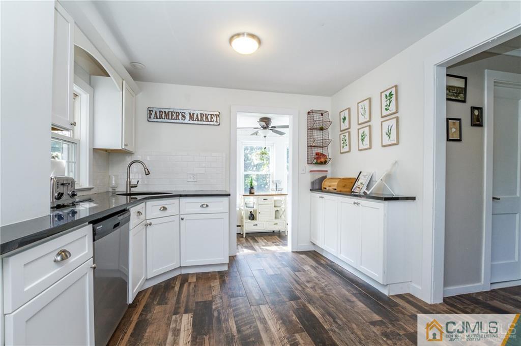 294 E Road Middletown, NJ 07718 - Photo 11 of 23 a kitchen with a refrigerator and white cabinets
