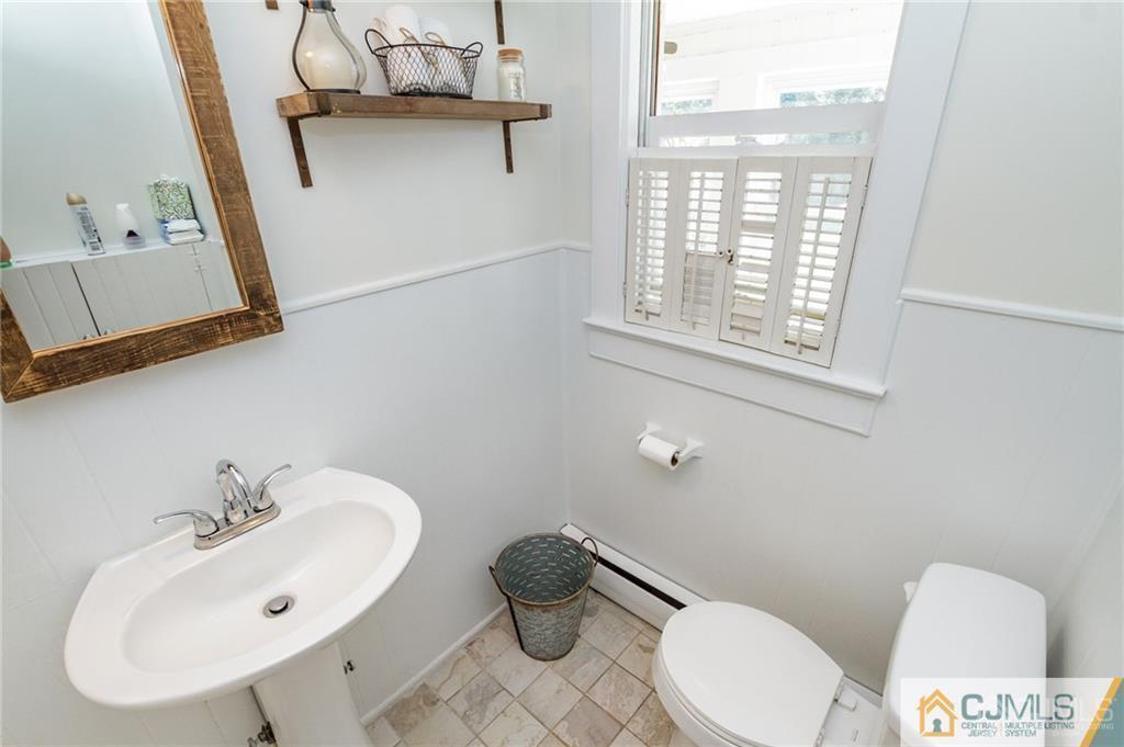 294 E Road Middletown, NJ 07718 - Photo 14 of 23 a bathroom with a sink mirror vanity and toilet