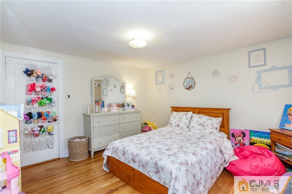 294 E Road Middletown, NJ 07718 - Photo 15 of 23 a bed room with a bed and a dresser