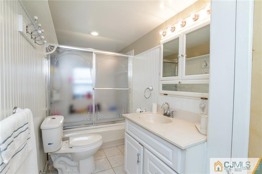294 E Road Middletown, NJ 07718 - Photo 18 of 23 a bathroom with a sink toilet and shower