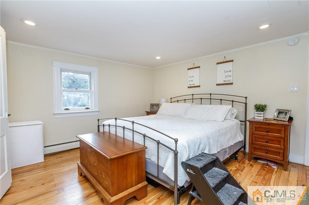 294 E Road Middletown, NJ 07718 - Photo 19 of 23 a bedroom with a bed and wooden floor