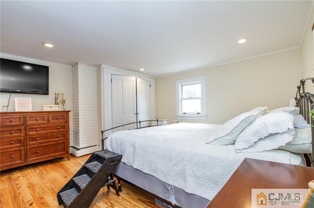 294 E Road Middletown, NJ 07718 - Photo 20 of 23 a bedroom with a bed and flat screen tv