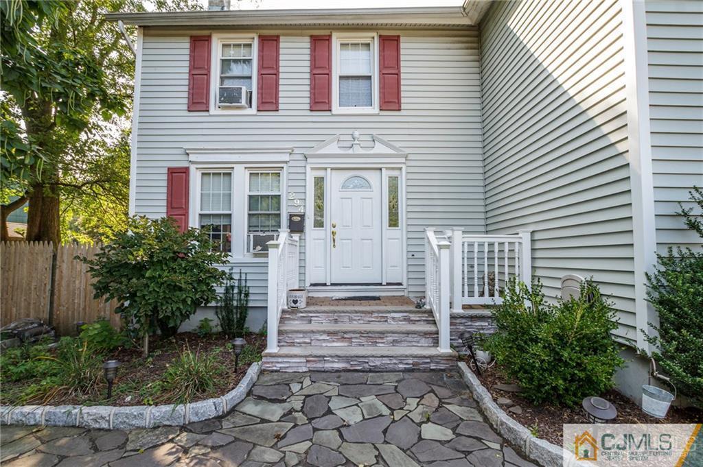 294 E Road Middletown, NJ 07718 - Photo 2 of 23 a view of a house with brick walls and plants