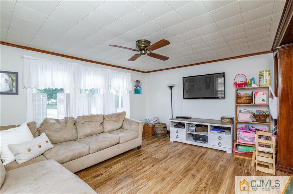 294 E Road Middletown, NJ 07718 - Photo 7 of 23 a living room with furniture and a flat screen tv