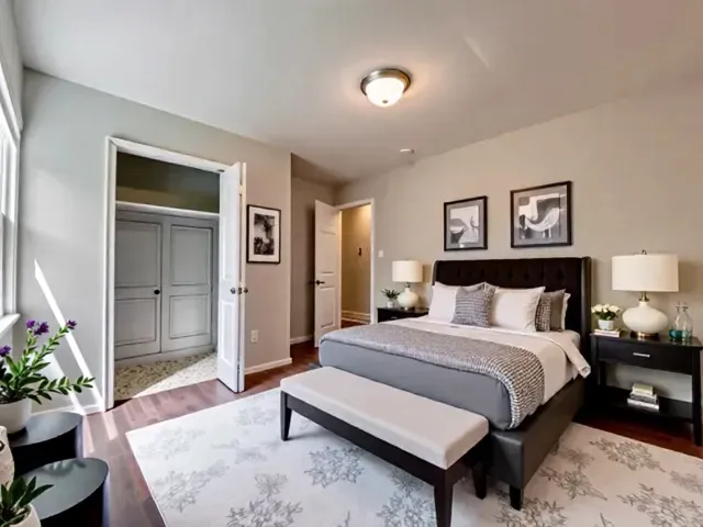 a spacious bedroom with a bed and a potted plant