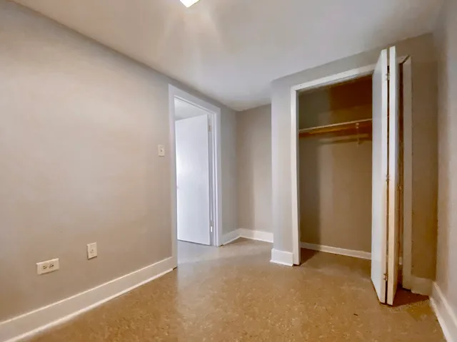 an empty room with closet area