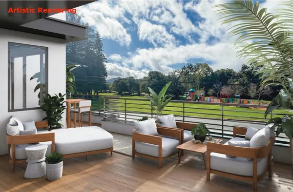 a view of a patio with couches potted plants and a big yard