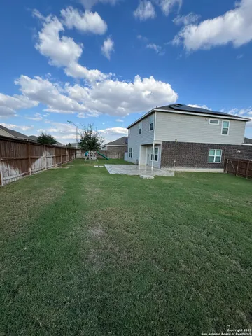 a view of a house with a yard and sitting area