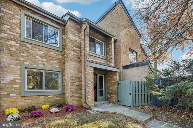 a view of a brick house with many windows