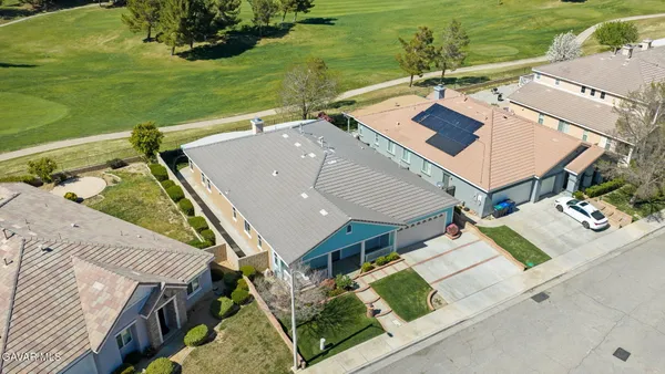an aerial view of a house with outdoor space and lake view