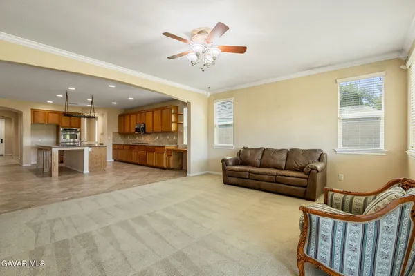 a living room with furniture and kitchen view