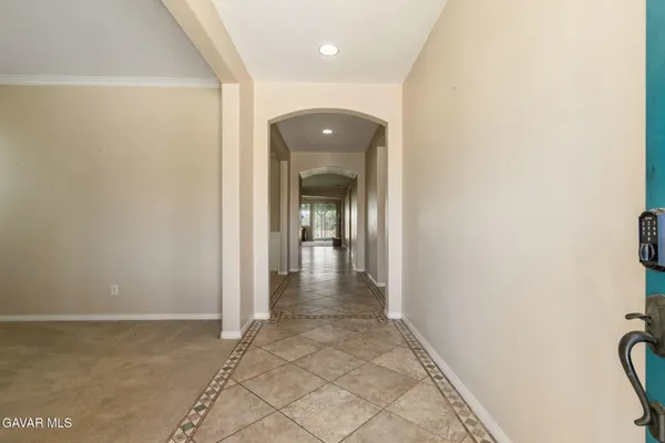 a view of a hallway with wooden floor and a large window