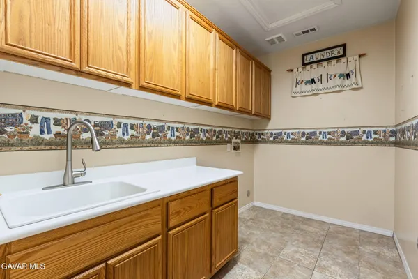 a kitchen with a sink and cabinets