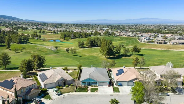an aerial view of residential houses with outdoor space and river