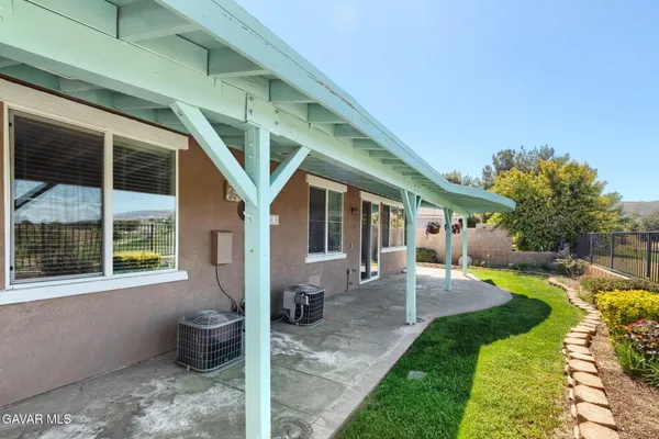 a view of a house with backyard sitting area and garden