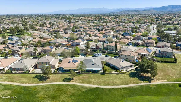 an aerial view of residential houses with outdoor space