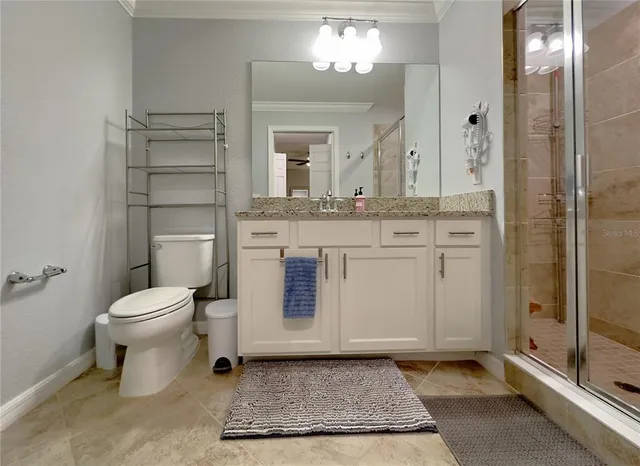 a bathroom with a toilet a sink and shower