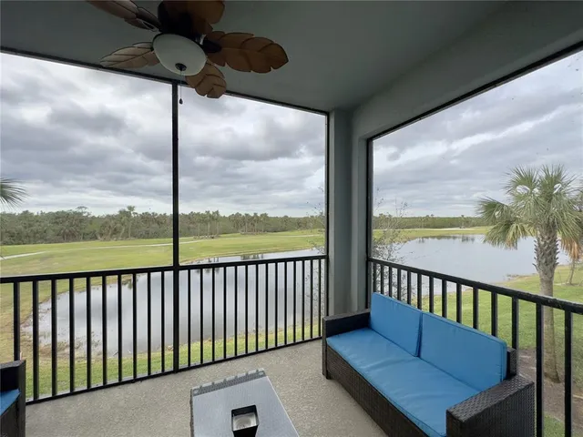 a view of a balcony with floor to ceiling windows with wooden floor