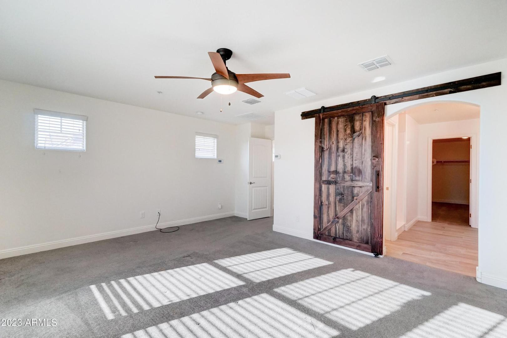2297 North Alsap Road Buckeye, AZ 85396 - Photo 15 of 36 a view of empty room with wooden floor and fan