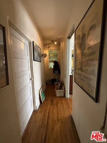 a hallway with wooden floor and furniture