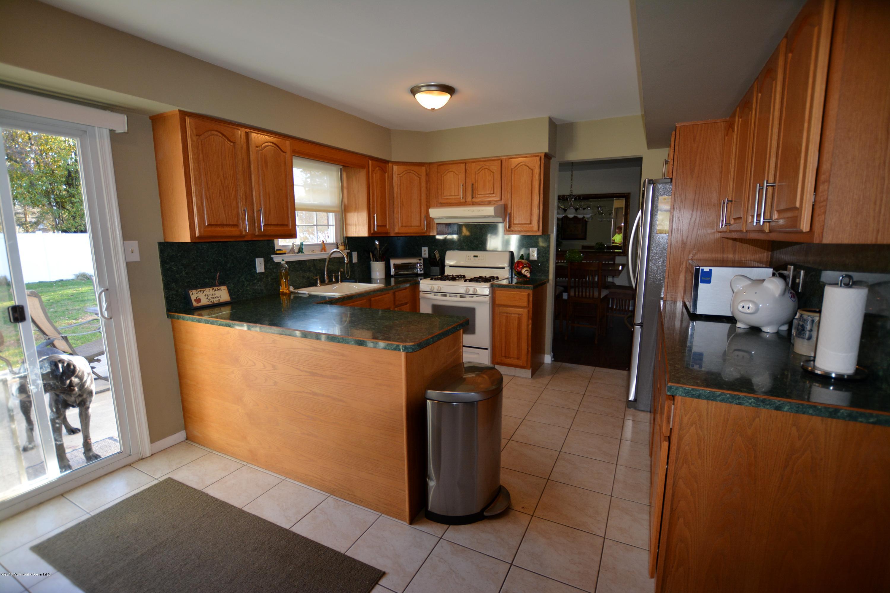 2 Appletree Road Howell, NJ 07731 - Photo 7 of 19 a kitchen with refrigerator a stove a sink and a microwave