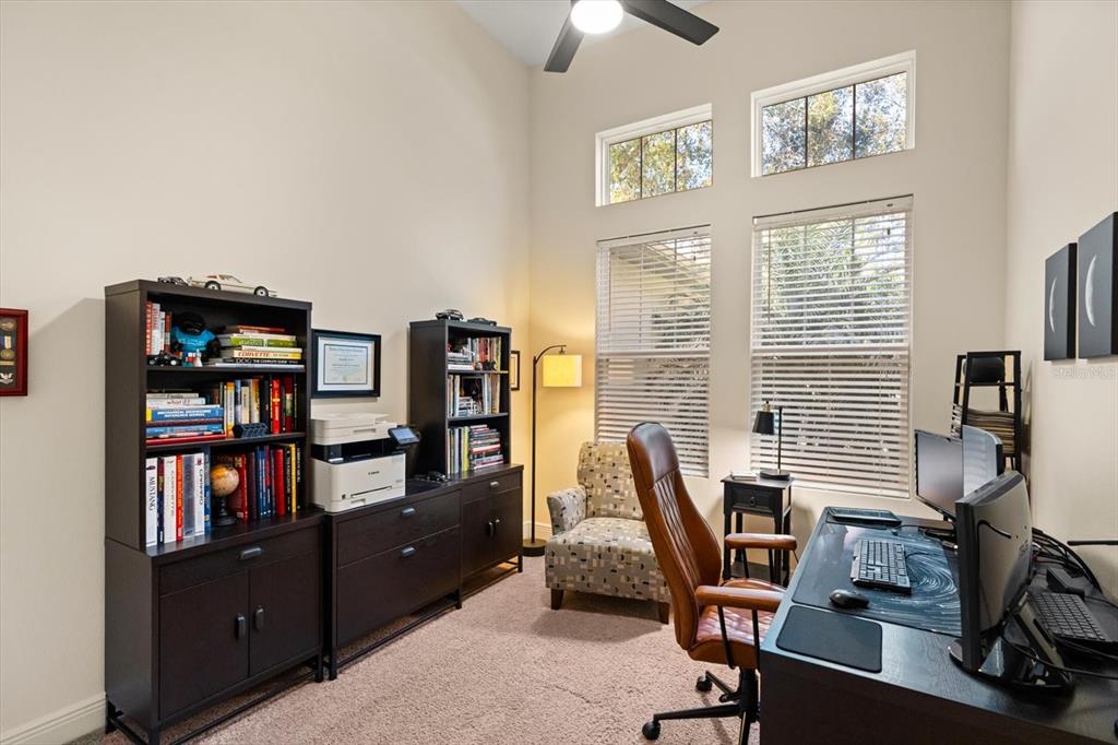 2709 Tree Meadow Loop Apopka, FL 32712 - Photo 14 of 31 a view of a workspace with furniture and a bookshelf