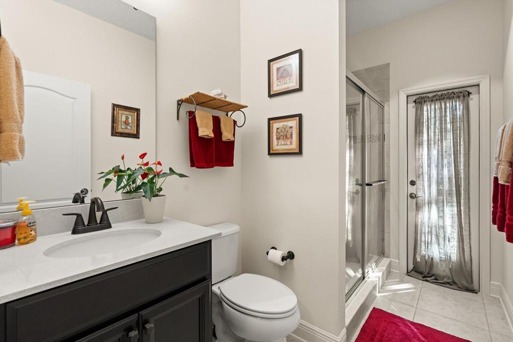 2709 Tree Meadow Loop Apopka, FL 32712 - Photo 18 of 31 a bathroom with a sink a toilet a shower and a mirror