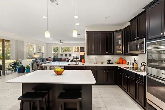 a kitchen with a sink a stove and cabinets