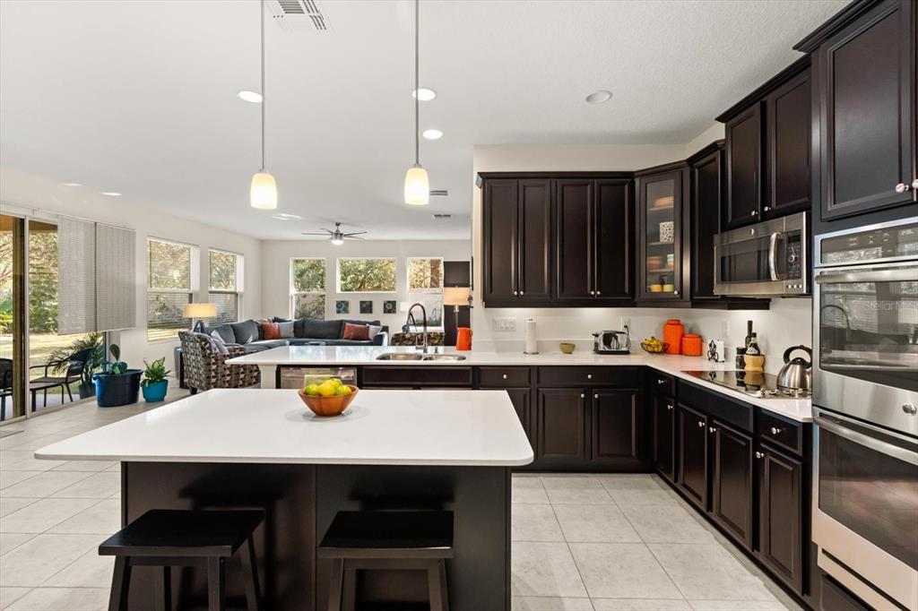 2709 Tree Meadow Loop Apopka, FL 32712 - Photo 3 of 31 a kitchen with a sink a stove and cabinets