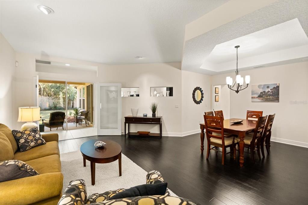 2709 Tree Meadow Loop Apopka, FL 32712 - Photo 6 of 31 a view of a dining room with furniture and wooden floor