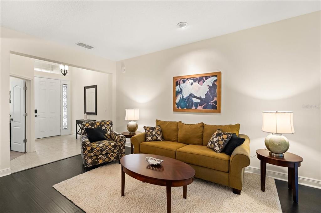 2709 Tree Meadow Loop Apopka, FL 32712 - Photo 7 of 31 a living room with furniture and a rug