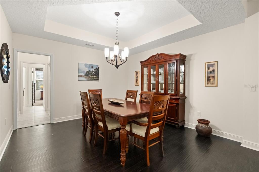 2709 Tree Meadow Loop Apopka, FL 32712 - Photo 8 of 31 a view of a dining room with furniture and wooden floor