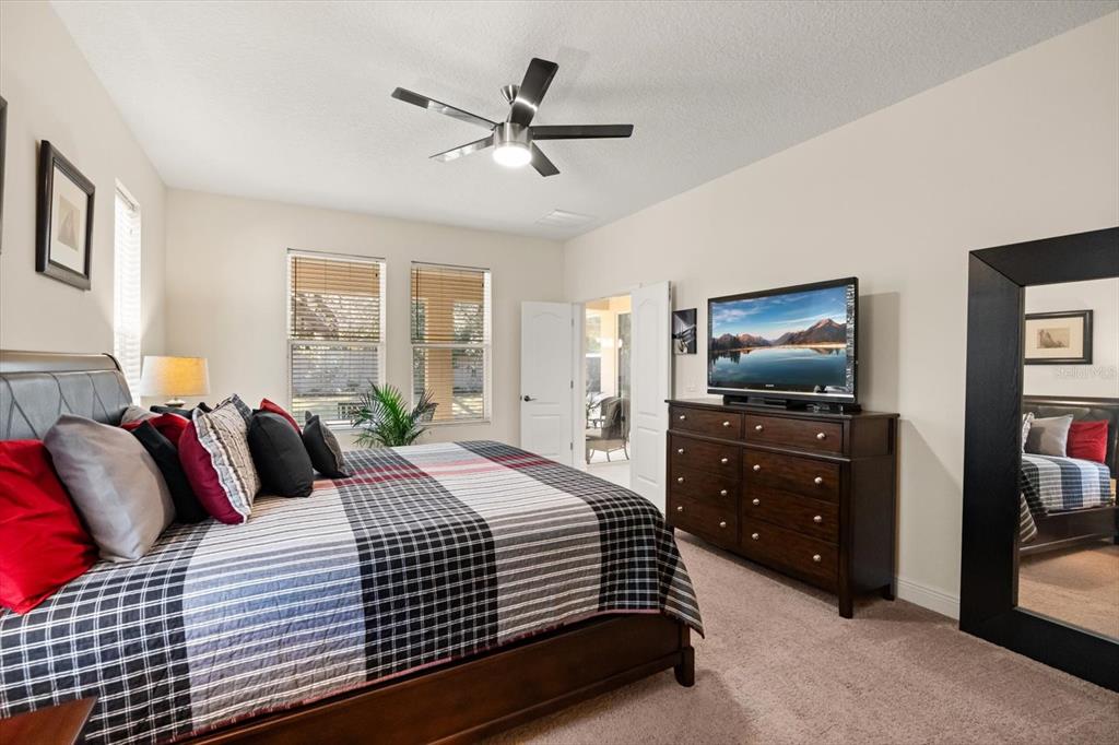 2709 Tree Meadow Loop Apopka, FL 32712 - Photo 10 of 31 a bedroom with a bed and a flat screen tv