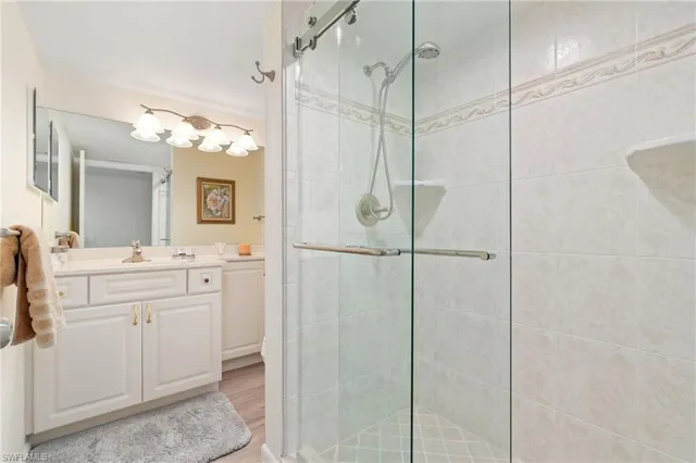 a bathroom with a shower a sink and mirror