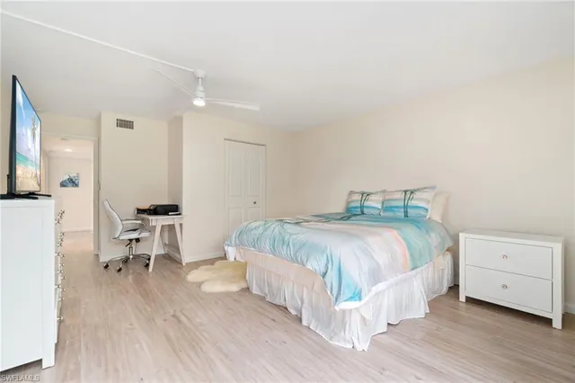 a bedroom with a bed and a table