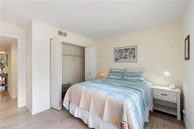 a bedroom with a bed and a lamp