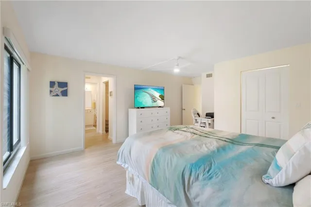 a spacious bedroom with a bed and a couch