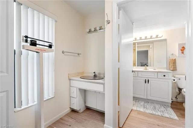a bathroom with double vanity sink a mirror and a shower