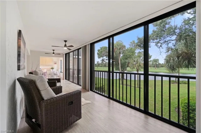 a living room with furniture and a floor to ceiling window