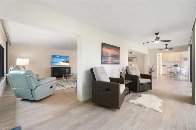 a living room with furniture window and wooden floor