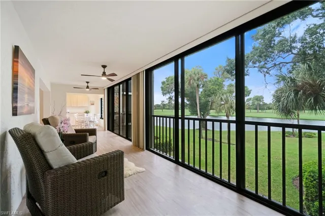 a living room with furniture tv and a large window