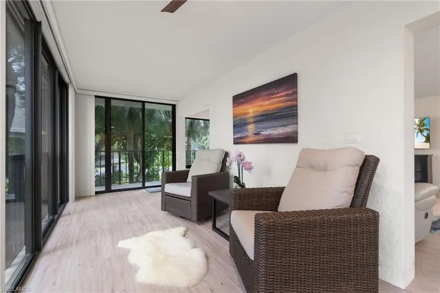 a living room with furniture and large window